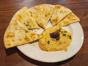 Roasted red pepper hummus and pita bread at Kalamaki Greek Eatery in Anna
