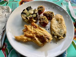 Zucchini flower and sage leaf in batter with aubergine and baked tomatoes  at La Cena di Pitagora in Ponte Nizza