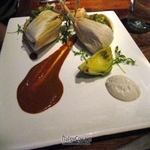 Sweet Corn And Cashew Tamales With Chili Spiced Portabella salsa verde, cashew coconut sour cream, avocado, raw cacao mole at Pure Food and Wine in New York City