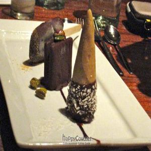 Trio Of Dark Chocolate Coated Indian Spiced Ice Chocolate cardamom ice cream cone, pistachio gelato ice cream sandwich, and chai tea creamsicle. at Pure Food and Wine in New York City