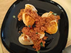 Pasta fiiled with pumpkin with vegan Bolognese sauce at Malerba in Bologna