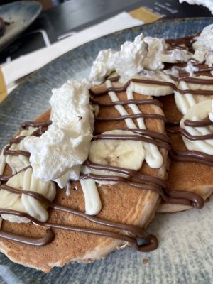 Vegan pancakes with Nutella, banana, and vegan whipped topping   at The Taste of Home in Trieste