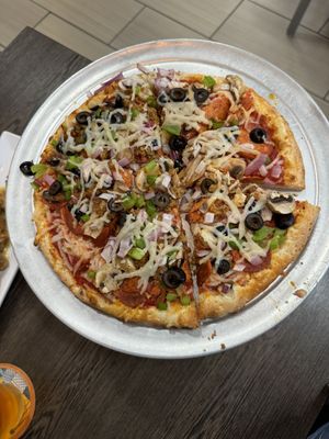 Supreme pizza with vegan pepperoni, sausage and cheese, complete with olives, bell peppers, onions, and more  at Pizza Bros in Visalia