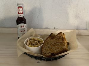 Pan de fuego (sandwich with kimchi and vegan smoked scamorza) with Verona salad (celeriac salad with walnuts and vegan mayonnaise) and Bio Cola  at Hambre Street Food in Verona