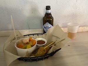 Spiedo Gonzales (chickpea skewer) with pickled veggies, ketchup and beer  at Hambre Street Food in Verona