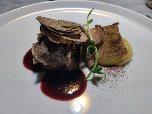 Redefine meat with red wine sauce, hazelnuts, truffle shavings, and potato puree at Soul Kitchen - Creatività Vegetale in Turin
