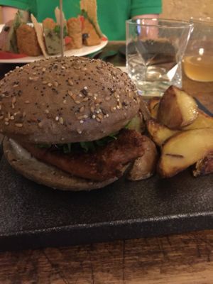 They ran out of Beyond Meat Burgers so the patty was replaced with the Beyond Sausage. In the background is the deconstructed taco.  at Soul Kitchen - Creatività Vegetale in Turin