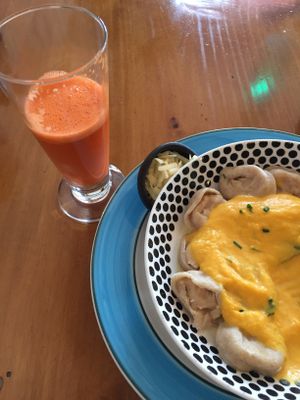Carrot ginger juice and walnut/cheese ravioli in pumpkin garlic sauce (sorry, mid-meal!). Seasonal autumn menu. at El Living in Puerto Natales