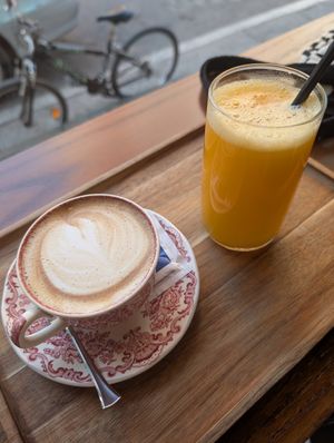 Cappuccino with oat milk and a fresh pressed orange juice at M'kanda in Shkoder
