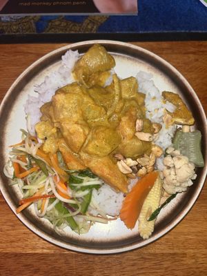 Family dinner: Khmer red curry, mango salad, veggies and peanuts  at Mad Monkey Phnom Penh in Phnom Penh