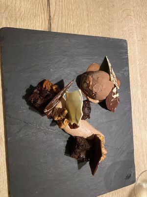 vegan chocolate dessert with chocolate walnut ice cream, chocolate mousse, brownie pieces and chocolate garnish  at Waanzinnig Tilburg in Tilburg