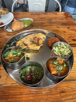 Earth thali and in the back, a pumpkin samosas   at Pondicheri in Houston