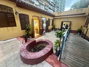 Outdoor courtyard with seating area behind me  at 日Rise in Macau