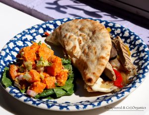 Chicken Free Philly Style Pita with Grilled Onions, Red & Yellow Peppers, Mushrooms, Lightly Seasoned Chicken Free Strips, and Mozzarella Cheese all on a Warm Pita with a side of Sweet Potato Salad.  at Sprouts Cafe in Gastonia
