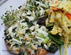 Green Veggie Pizza! Basil Marinated Green Veggies including: Broccoli, Green Pepper, Cabbage, Celery, and Green Tomatoes from our own garden on a personal sized traditional crust with steamed Curly Kale, a Drizzle of Avocado Herb Vinaigrette!  at Sprouts Cafe in Gastonia