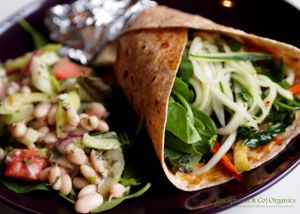  Thai Veggie Wrap! Grilled Veggies seasoned with a dusting of Chinese Five Spice Powder on a 7-Grain Flax Wrap with Thai Peanut Butter Sauce with a Sweet & Spicy Cucumber & Herb Salad to Garnish!   at Sprouts Cafe in Gastonia