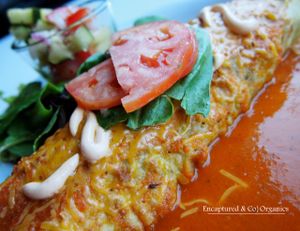 Veggie Brown Rice Enchilada! Seasoned, Organic grilled Veggies with Long Grain Brown Rice in a Spinach Tortilla with Chipotle Aioli and a mixed cheeses baked and topped with homemade enchilada sauce!   at Sprouts Cafe in Gastonia
