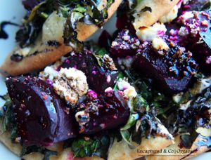 Beety Green Pizza! Organic, cooked, beautiful red beets and marinated leafy greens including kale, chard, and collard greens on a traditional crust with olive oil, feta cheese, and finished with a drizzle of balsamic reduction!   at Sprouts Cafe in Gastonia