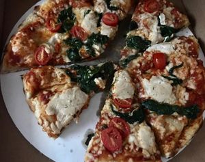 Cashew ricotta, cherry tomatoes, spinach, and vegan mozzarella.  at Wheat Penny Oven and Bar in Dayton