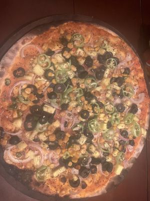 Fiery pizza- no cheese with olives, capsicum ( pepper), chili pepper, chili flakes, sweet corn, onion and swapped kocchi for pineapple  at MozzarElla By Nero Kitchen in Ella