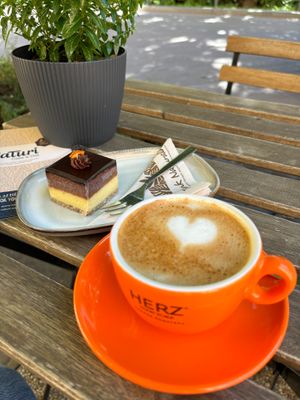 Our vegan orange chocolate cake with a plant based cappuccino from the mid roast Herz espresso. at NaTuri Café & Deli in Budapest