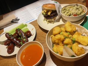 Cauli bites, mac burger, pesto pasta and chicken wings   at Veggie Grill by Next Level - Downtown in Seattle