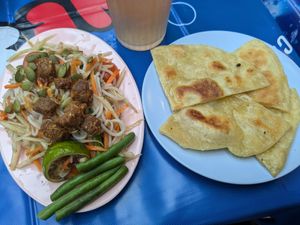 Papaya salad and roti at muan in South West London
