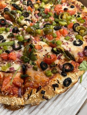 🌟 Amazing 🌟 vegan pizza with sesame crust, vegan cheese and loads of veggies   at Red Swan Pizza in Hamilton