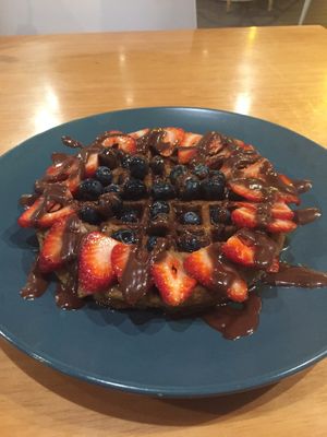 Waffles with blueberries and strawberries  at Raw Cafe in Lima
