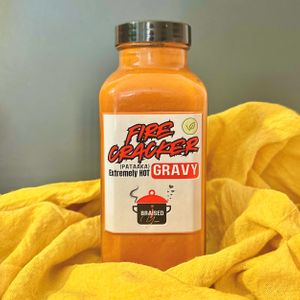 Firecracker Gravy – bold, spicy, and deeply flavorful! This rich, slow-cooked vegan gravy adds a fiery kick to any meal. 100% gluten-free and made with in-house spices! at Braised Yum in Gainesville