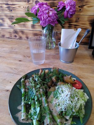 Grilled asparagus with mushroom sauce and baked potatoes at Avocado Vegan Bistro in Gdansk