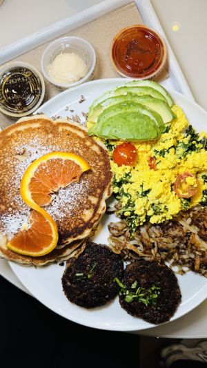 Bleecker Street Breakfast: organic tofu scramble. hash browns. maple tempeh sausage. pancakes. maple syrup. orange. sriracha.   at chloe in New York City