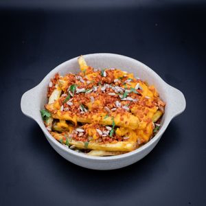 Loaded cheesy fries with soy crumb at O Gambuzino Burger Clube in Lisbon