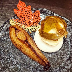 Dessert: vanilla poached pear with vanilla ice cream, a blanket of pear skins and an autumn leaf (vegetarian) at Cochon&Carot in Hemiksem