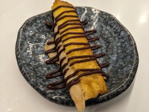 Dessert: pancake filled with pine apple coulis, finished with grilled pine apple and chocolate sauce  (vegan) at Cochon&Carot in Hemiksem