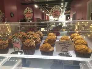 Cupcakes behind glass at Get Caked Bakery in Rochester