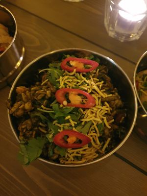 Bhel Puri:
Bombay’s best loved street food. Puff rice with crisp gram threads, peanuts & tantalising spiced sweet & sour dressing. at Mowgli in Knutsford