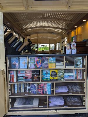 Bookshelves - all secondhand - and a few merch items at Journey Coffee & Books in Bern