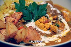 Punjabi Curry with yellow rice, vegan cream, sesamesalt, mango chutney and ovenbaked bombay chili potatoes! at Cafe Bamboo in Arhus