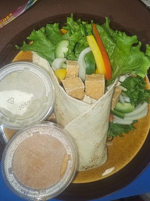 Tofu Taco Thai Curry: Tortilla, Fried Tofu, Green Lettuce,  White Onion,Bell Pepper, Red and Green Curry Sauce on the side  at Gindee's Vegan - Maybe closed in San Antonio