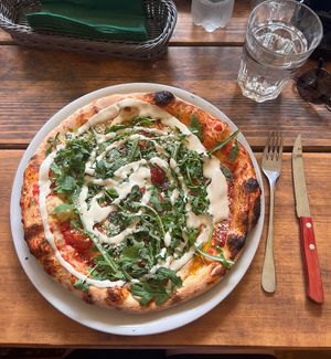 Delicious vegan Pizza with Rucola and cashew toppingg  at Restaurant Camp Bohinj in Bohinjsko Jezero