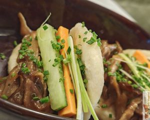 Peking-style buns, Le bao à la pékinoise (vegan) two homemade buns bao style, stuffed with shredded oyster mushroom, carrot, cucumber and leek, Chinese barbecue sauce. at Slow in Paris