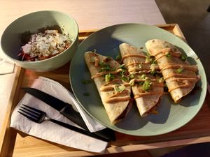 Quesadilla trio, one jackfruit, one gyro “meat” and one falafel. Comes with a side Greek salad   at Just Falafel Vegan Cafe in Houston