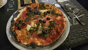 Vegano pizza...very thin. I didn't like the sauce, thickness or the veggies where were very "fiberish" at Grazie a Dio è venerdi in Rome