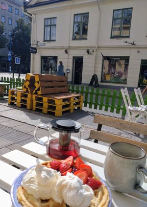 Belgian waffle with berries, cream and ice cream. at Queen Beans in Uppsala