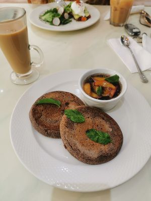 Superfood pancakes and oat milk coffee at Mani's Cafe in Muscat
