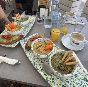 avocado toast, carrots with chickpea paste (like hummus) and bean paste with breadsticks. you also get one orange juice and one hot drink (we got cappucino with soy milk)  at Così Com'era in Alberobello