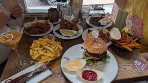 My vegan burger and chips in the foreground at Loetje in Bergen
