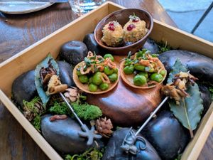 Peas & fava beans, zucchini tempura, smoked porcini skewer at Surrell in Seattle