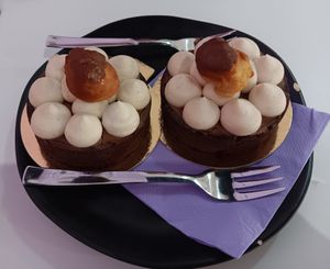 Chocolate gianduja creme cakes with a profiterole on top at Pasticceria Vegana Biologica La Magnolia in Verona
